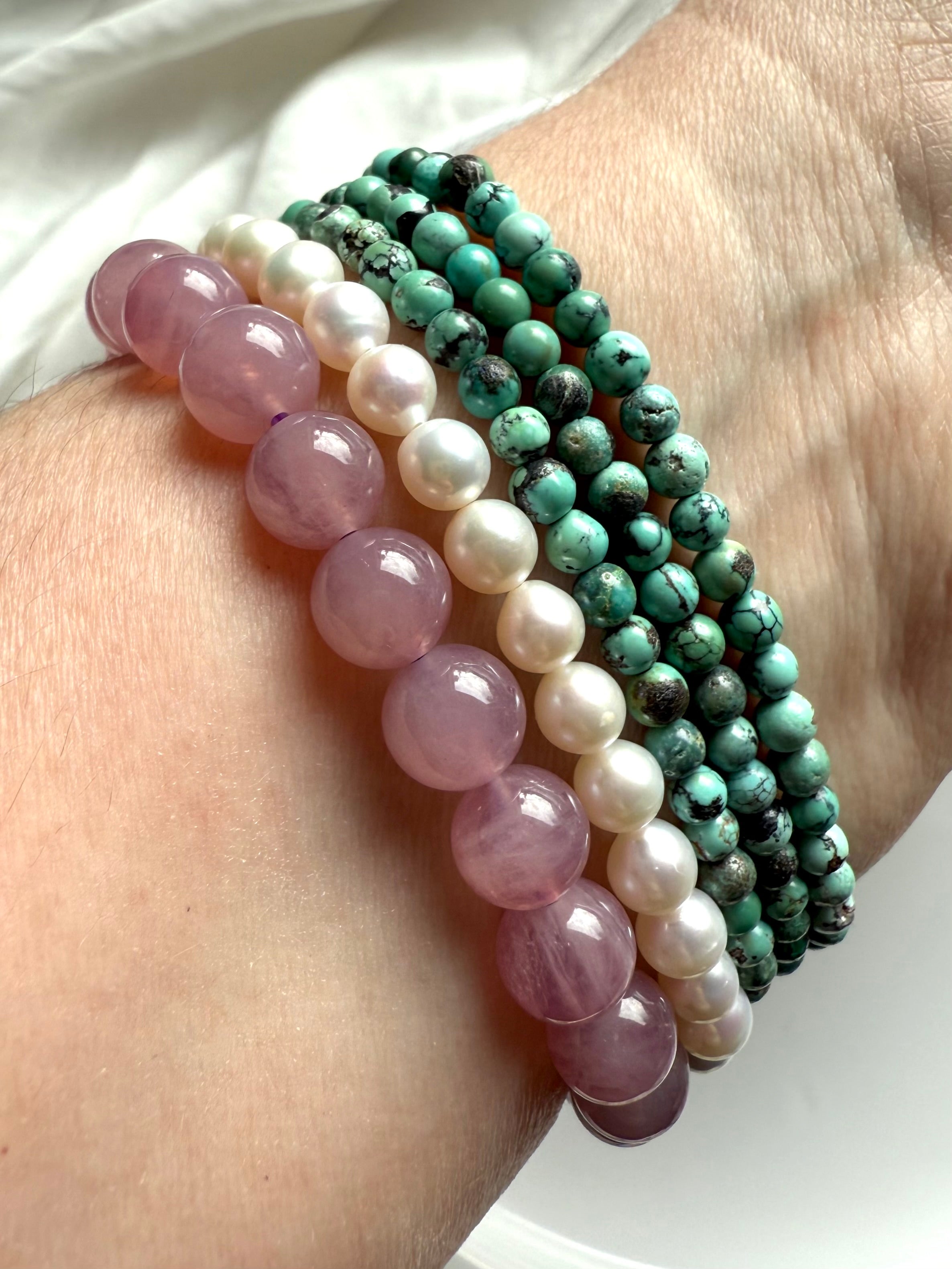 Crystal bracelet stack with lavender rose quartz, pearl, and turquoise for love, peace + heart chakra healing