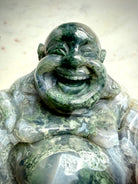 Closeup view of a Large Moss Agate Laughing Buddha statue highlighting detailed hand carving