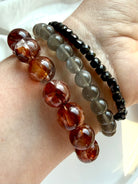 Fire Quartz bracelet with deep red and smoky Red Hematoid Quartz beads styled with Black Moonstone and Faceted Spinel bracelets
