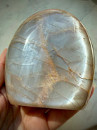 Peach Moonstone freeform held in hand with luminous silver Moonstone shimmer, crystal for intuition and Sacral Chakra energy