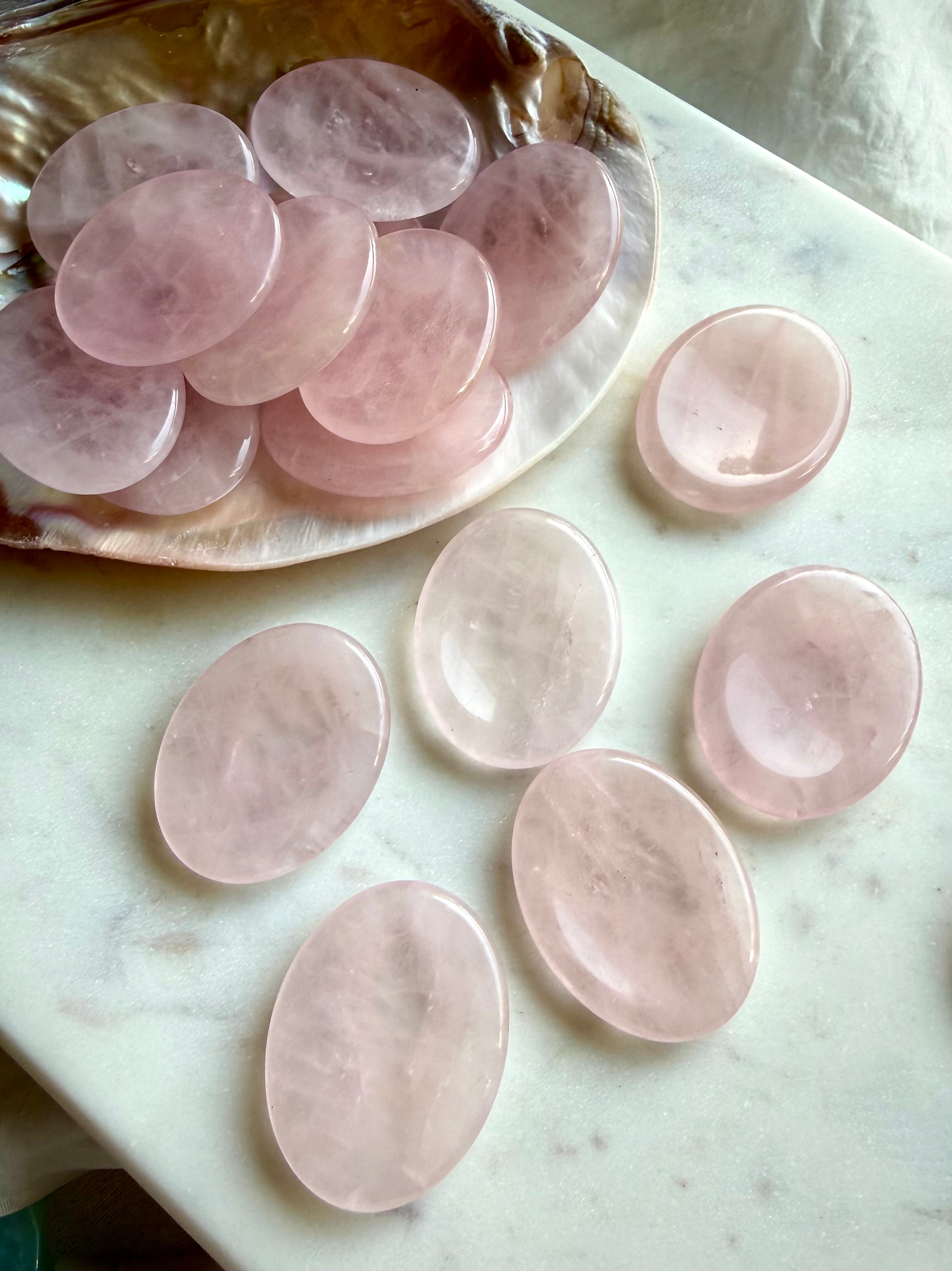 rose quartz worry stones on a shell oval thumb stones for calm love and heart chakra healing