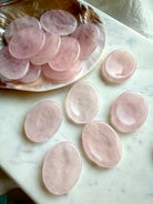 rose quartz worry stones on a shell oval thumb stones for calm love and heart chakra healing