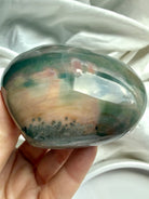 Glossy polished Ocean Jasper heart stone with soft teal and peach color banding