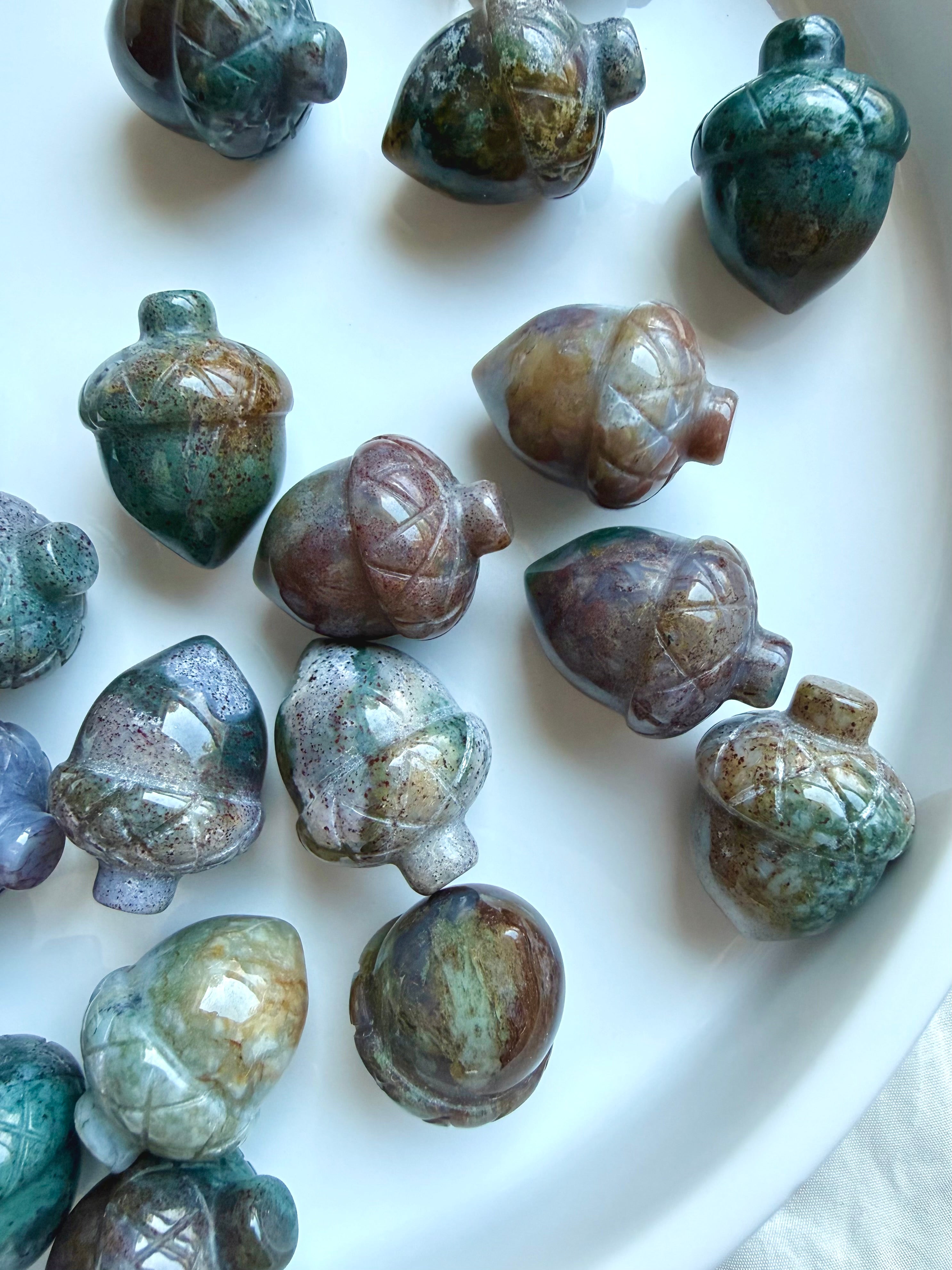 Mini Ocean Jasper acorns showing teal, lavender, mauve and earthy tones with natural mottling and glossy polish