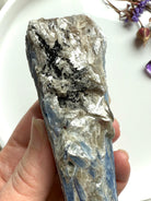 Close-up of raw blue kyanite and muscovite showing silvery mica sparkle, crystal texture and natural mineral layering