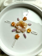 Crystal grid made with Golden Healer Quartz mini star carvings styled with Flower Agate, Kunzite, and Clear Quartz crystals