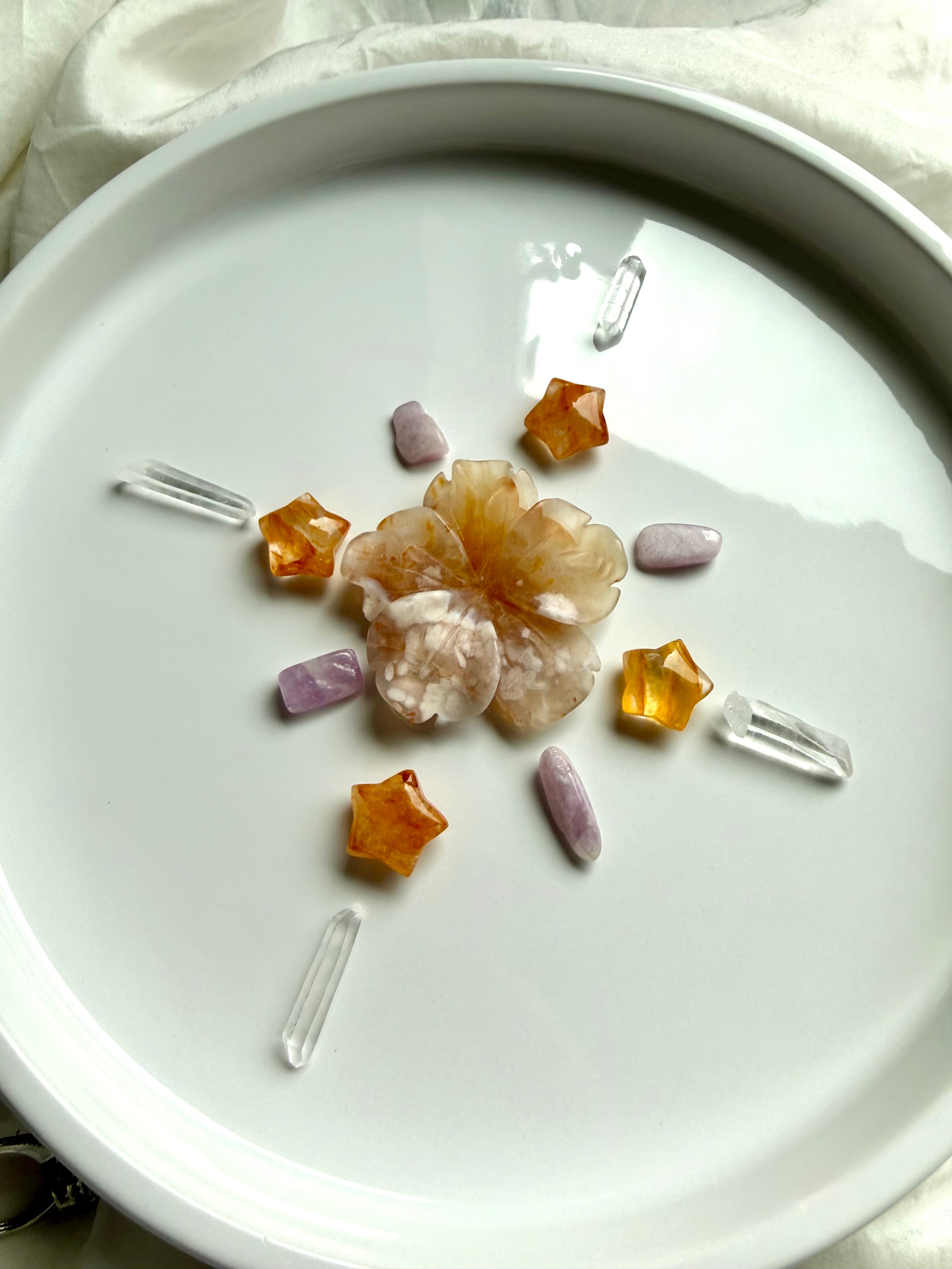 Crystal grid made with Golden Healer Quartz mini star carvings styled with Flower Agate, Kunzite, and Clear Quartz crystals