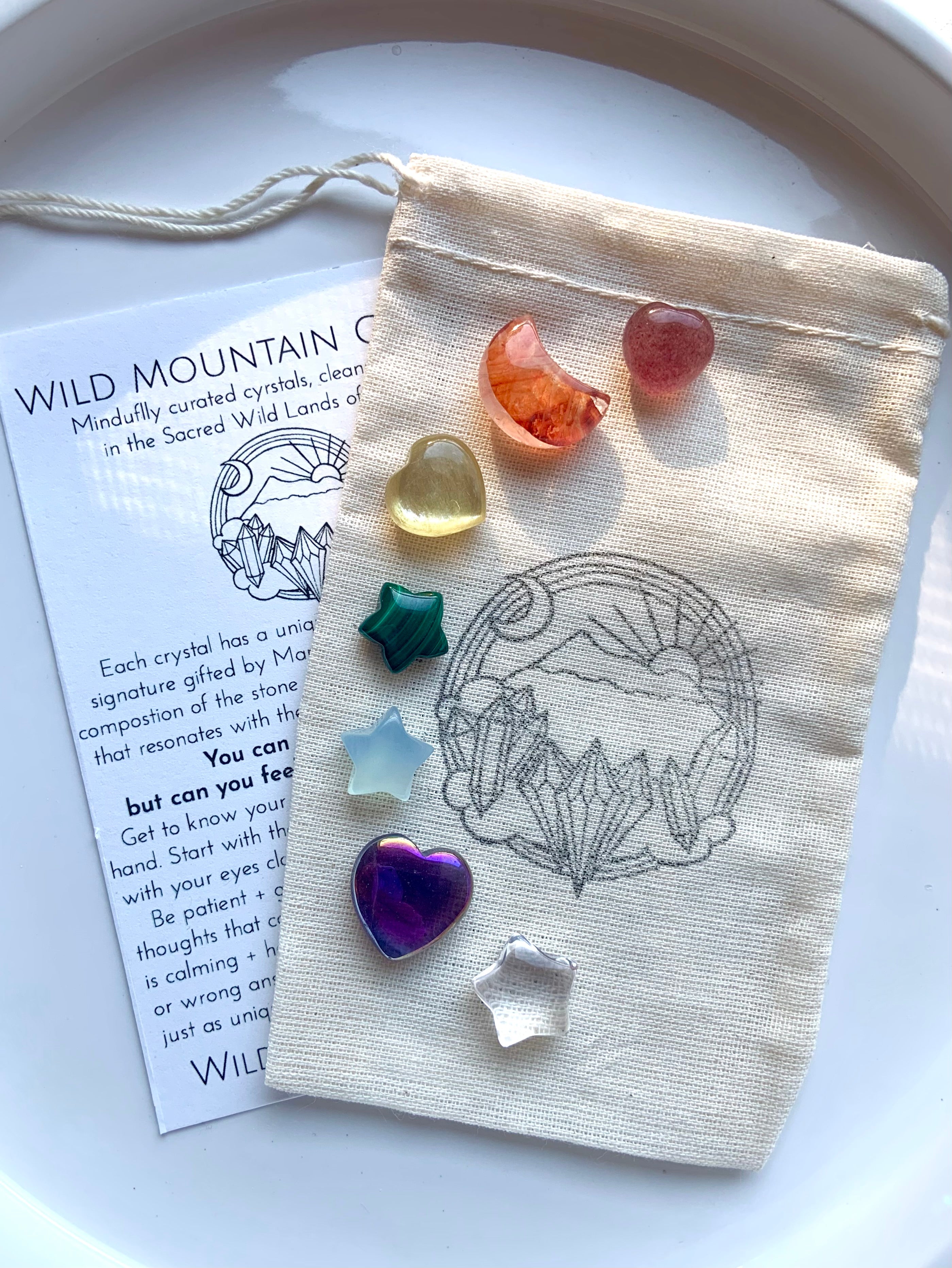 Chakra crystal set with 7 mini carved gems — heart, moon & star shapes in rainbow colors with info