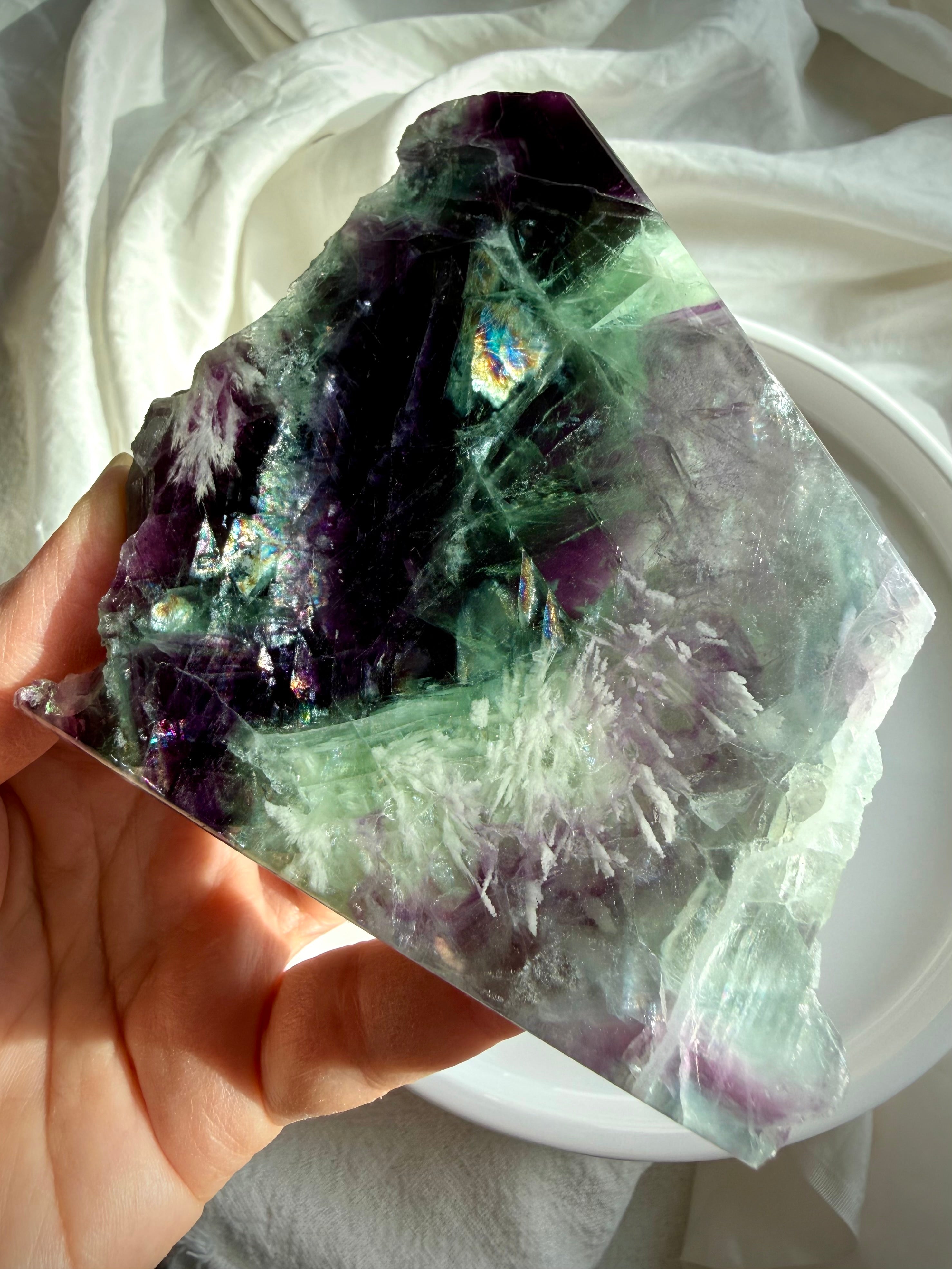 Luminous rainbow fluorite slab with green and violet hues and delicate scolecite snowflakes for peaceful focus and energetic clarity