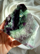 Luminous rainbow fluorite slab with green and violet hues and delicate scolecite snowflakes for peaceful focus and energetic clarity