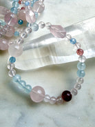 mixed bead crystal bracelet showing variation in bead sizes and shapes, rose quartz aquamarine strawberry quartz bracelet with soft feminine color palette