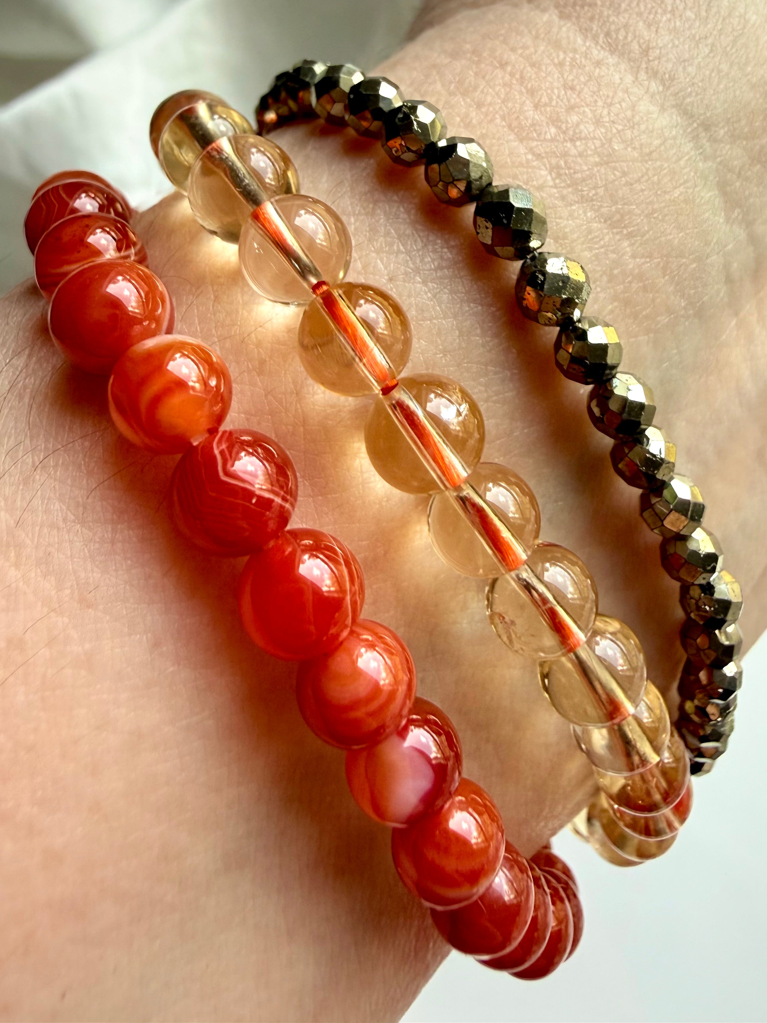 Showing our faceted Pyrite and Carnelian bracelets worn with Natural Citrine