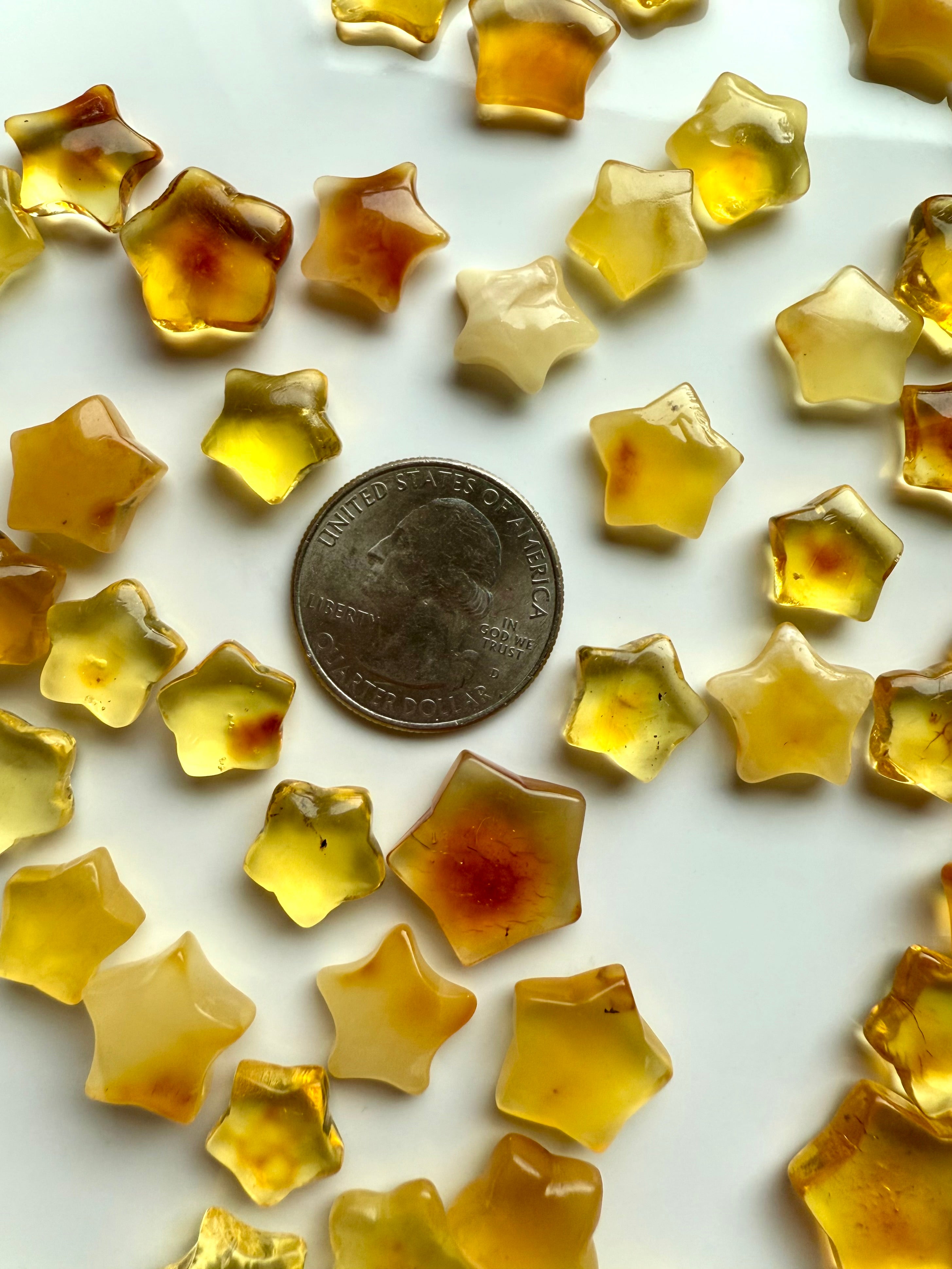 Mini Amber Star crystals with U.S. quarter for size comparison – grounding Solar Plexus healing stones