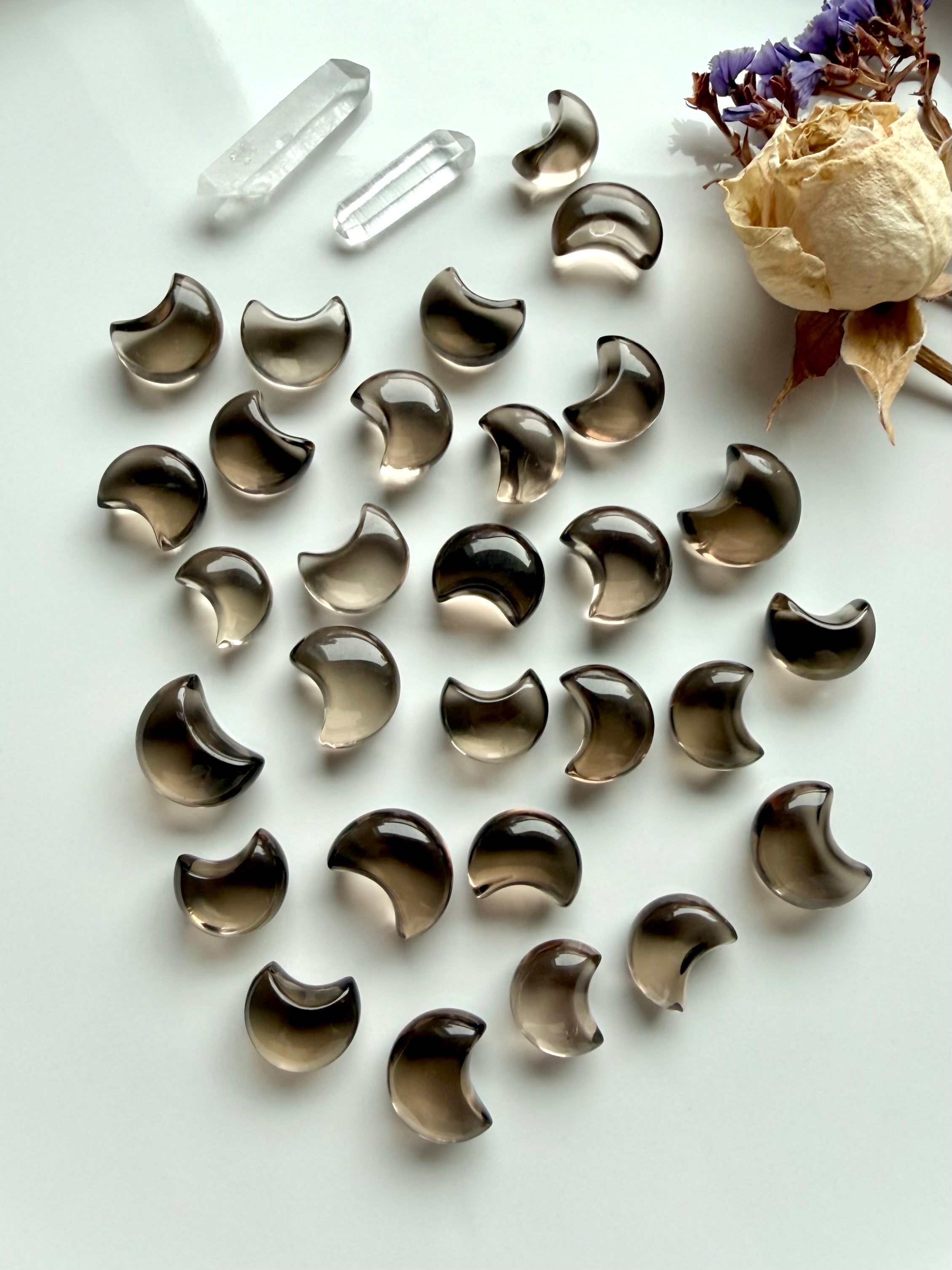 Mini Smoky Quartz crescent moon crystals arranged together showing translucent brown tones, glossy polish and natural color variation