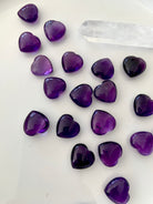 Overhead view of Mini Amethyst hearts with a clear quartz point — heart chakra and crown chakra mini crystals