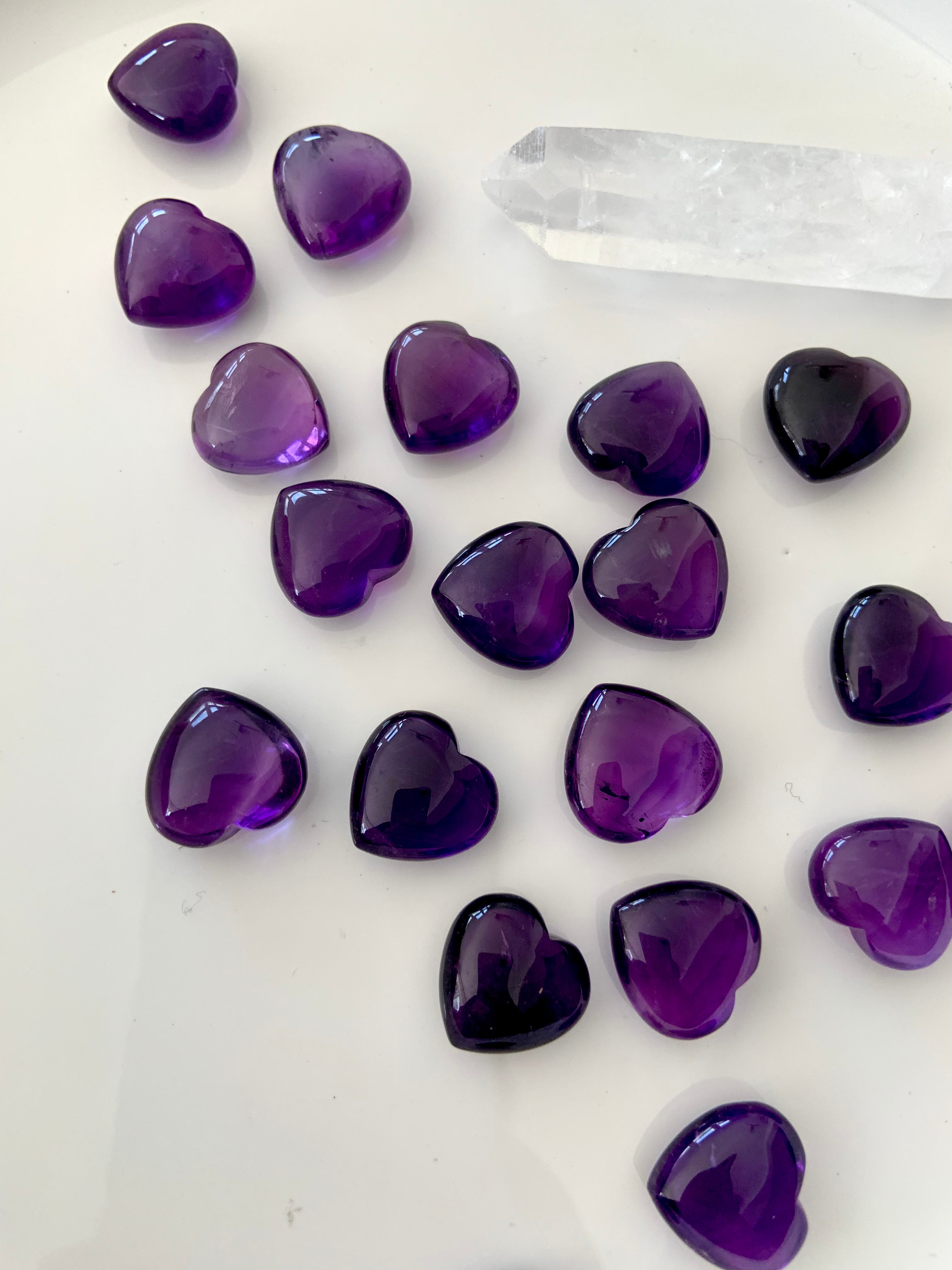 Overhead view of Mini Amethyst hearts with a clear quartz point — heart chakra and crown chakra mini crystals