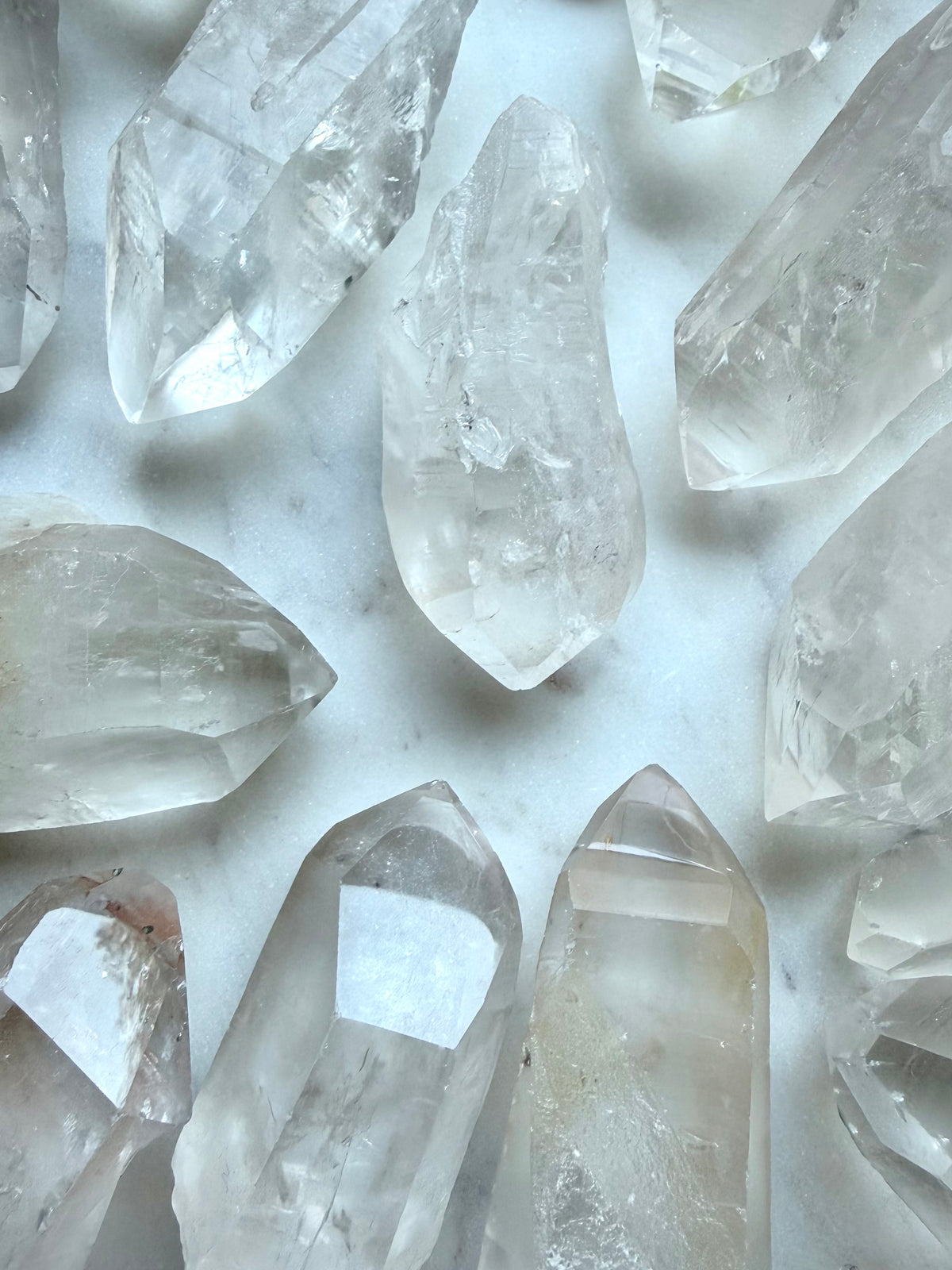 Rough Lemurian Quartz points from Brazil with natural ladder lines, varied terminations, and unique crystal formations