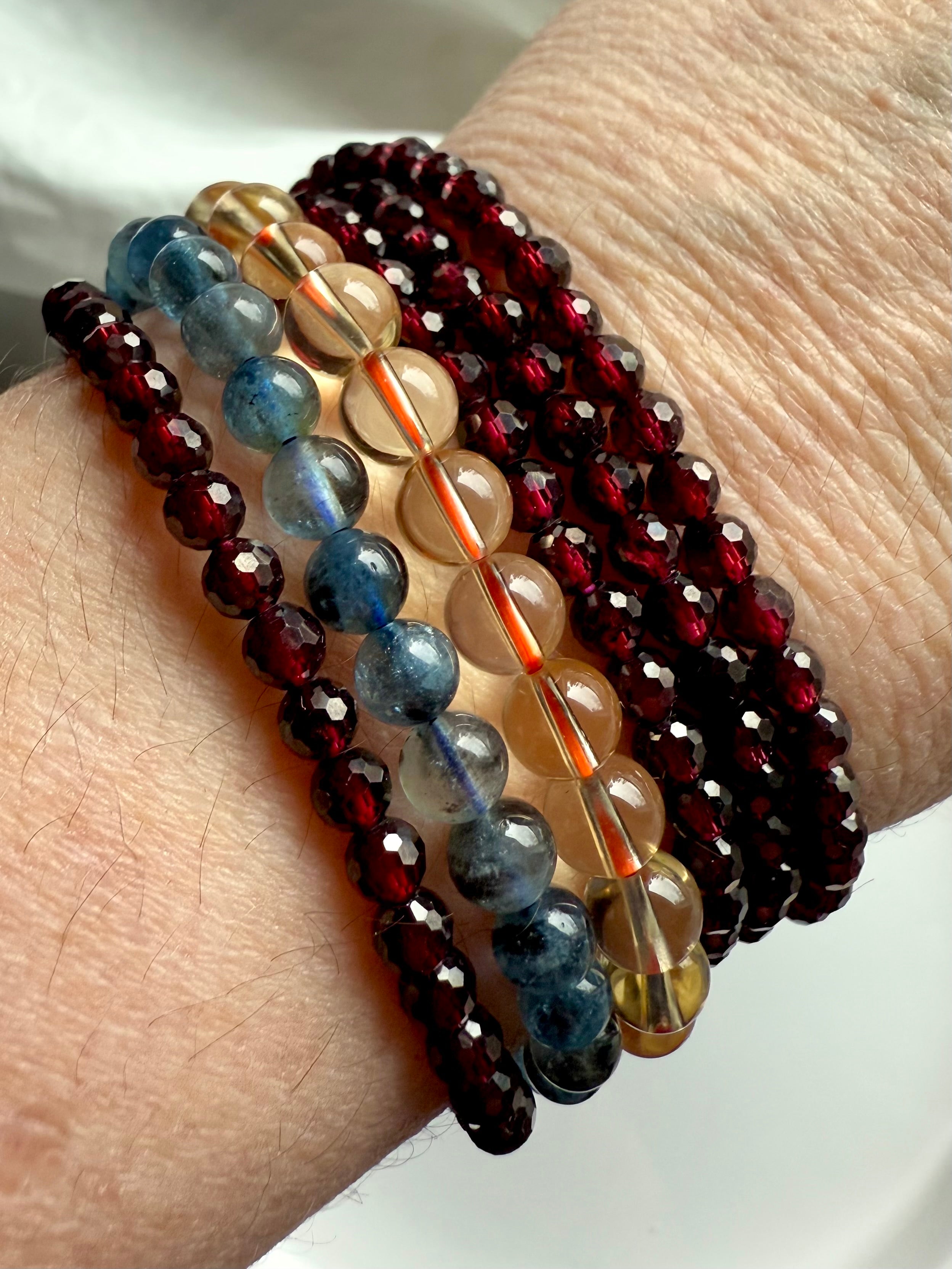 Showing both options of our faceted Red Garnet bracelets worn with Natural Citrine + Aquamarine
