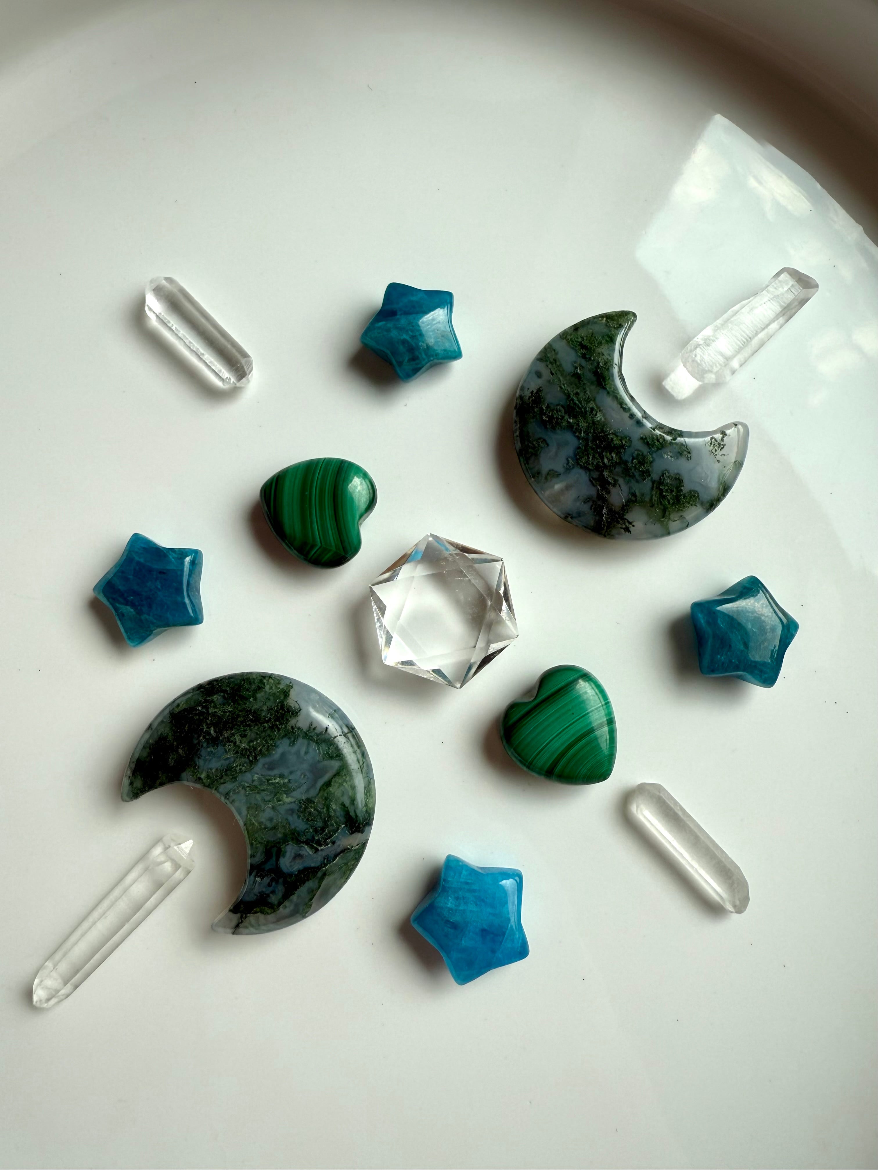 Moss Agate crescent moon carvings in a geometric crystal grid arrangement with mini crystal carvings, quartz points, and a clear quartz hexagon center.