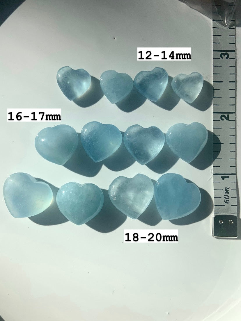  Aquamarine crystal hearts in 3 rows by size with measuring tape — mini hearts sized 12–14mm, 16–17mm, 18–20mm for throat chakra crystal healing.