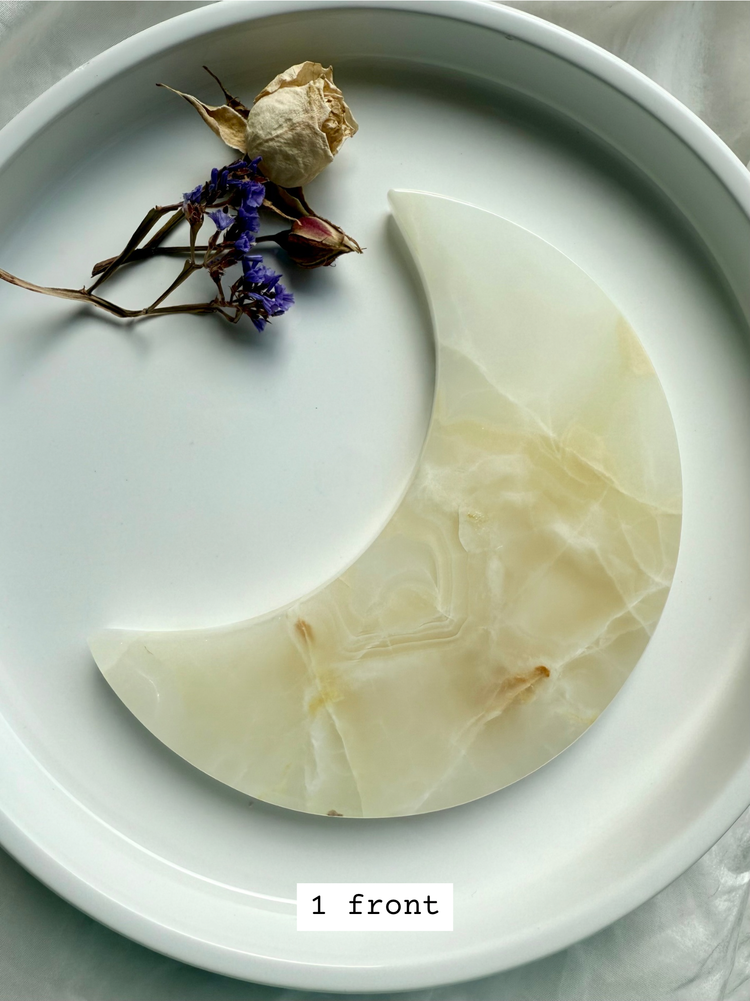 White Onyx Crescent Moon Plate, creamy beige with subtle golden banding, crystal moon carving front view.