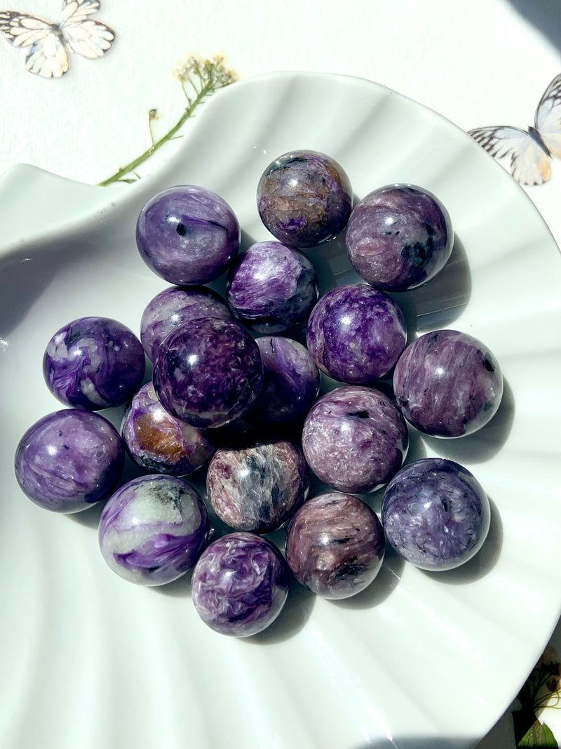 Purple Charoite mini spheres with beautiful shimmering patterns in the stone.