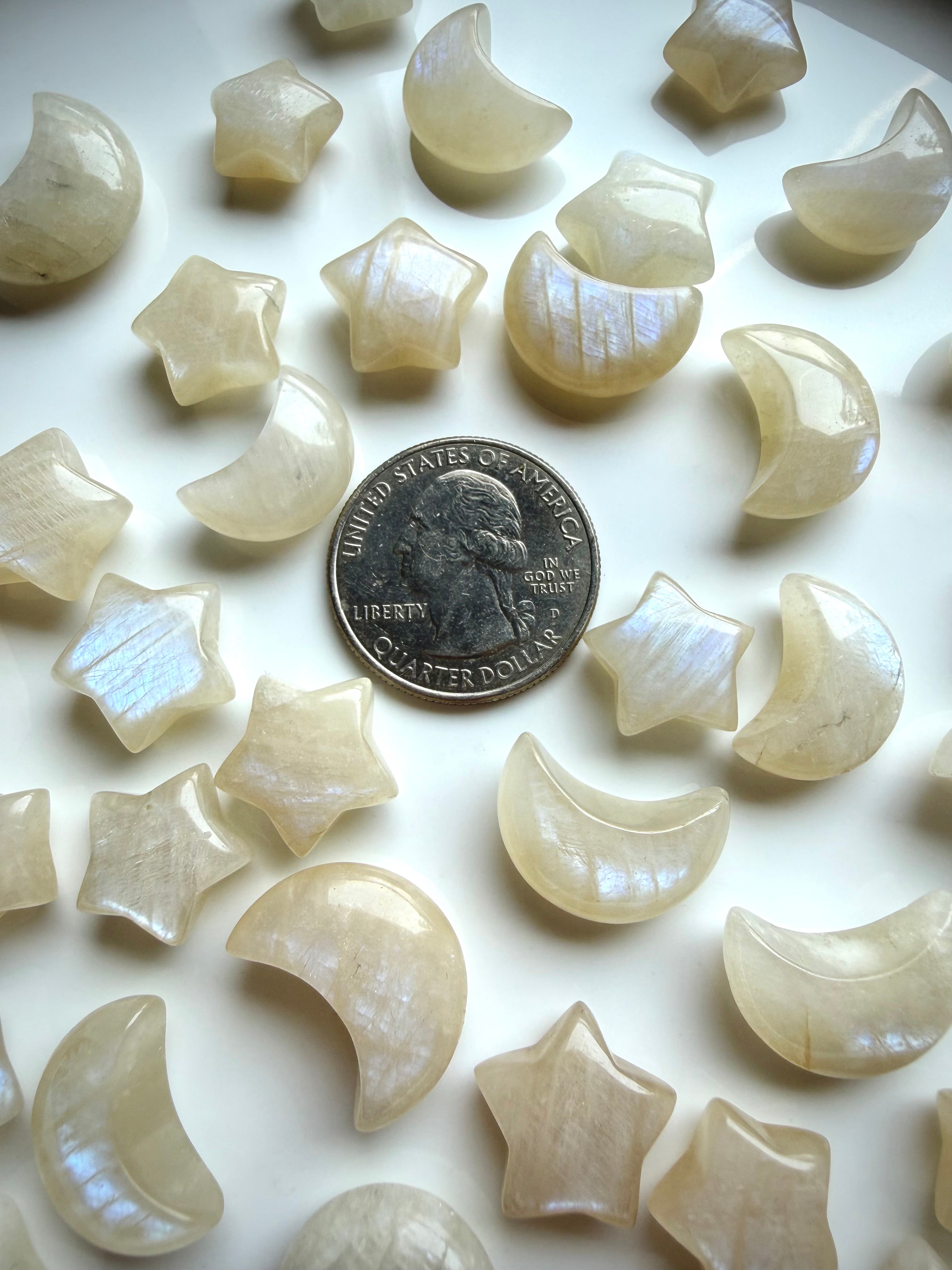 Mini Moonstone crystal carvings with blue flash and quarter for size reference