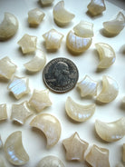 Mini Moonstone crystal carvings with blue flash and quarter for size reference