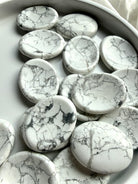 White Howlite worry stones with unique gray marbling and polished thumb indentations for meditation and stress relief