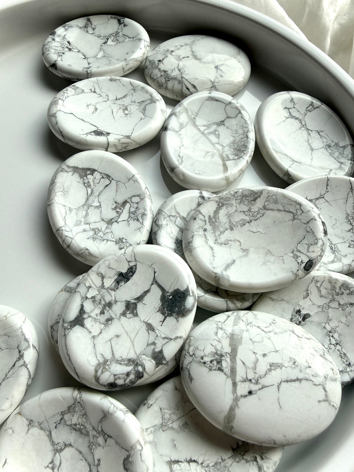 White Howlite worry stones with unique gray marbling and polished thumb indentations for meditation and stress relief
