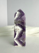 Dream Amethyst crystal point with dramatic purple and white zigzag banding, ideal for meditation, spiritual insight and energy balance