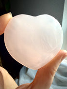 UV reactive Mangano Calcite heart glowing bright pink under blacklight from natural fluorescence