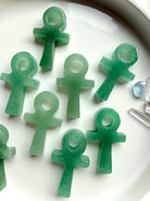Assorted green aventurine ankh carvings with natural variation in color tone and stone inclusions