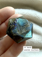 back side of faceted labradorite star of david crystal with glowing blue flash and geometric faceted finish number 13