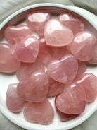 Polished Rose Quartz hearts showing natural variations in soft pink color, clarity and translucent crystal patterns