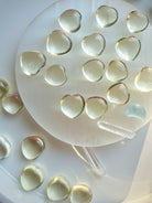 Mini Lemon Citrine heart crystals arranged on a selenite plate, uplifting yellow gemstone hearts for positivity and confidence