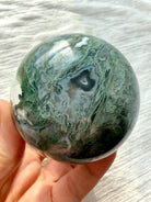 Moss Agate sphere with intricate mint-green dendrites, blue-gray chalcedony banding and deep forest green inclusions