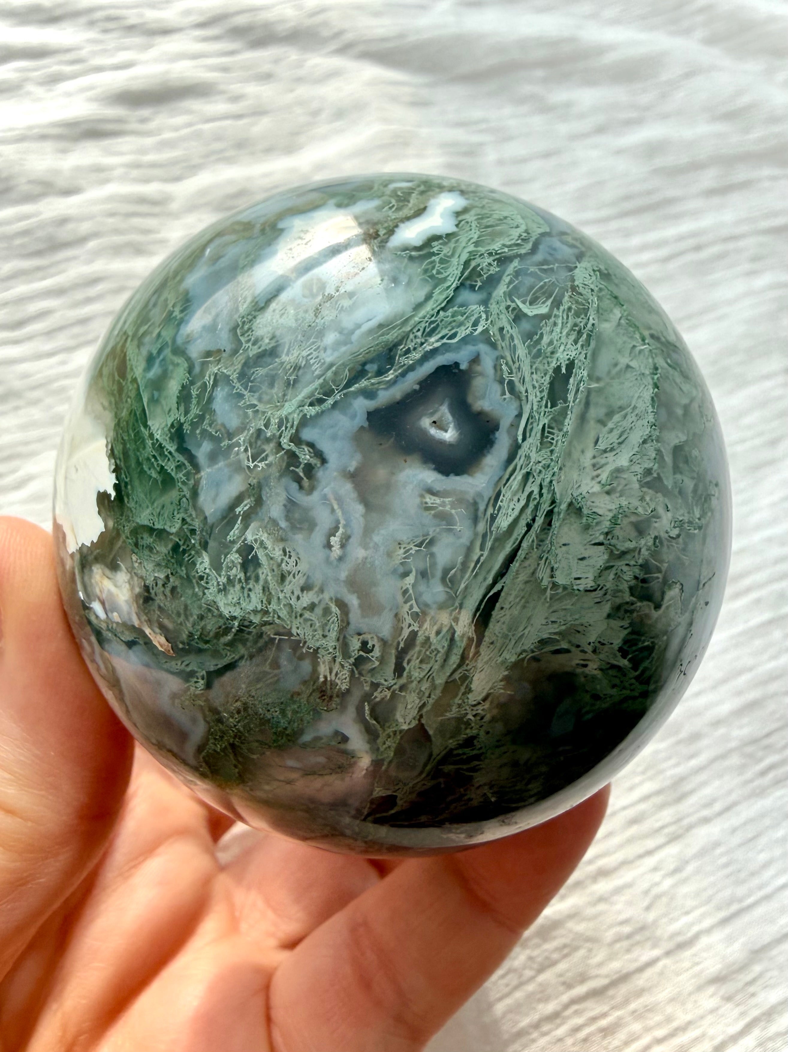 Moss Agate sphere with intricate mint-green dendrites, blue-gray chalcedony banding and deep forest green inclusions