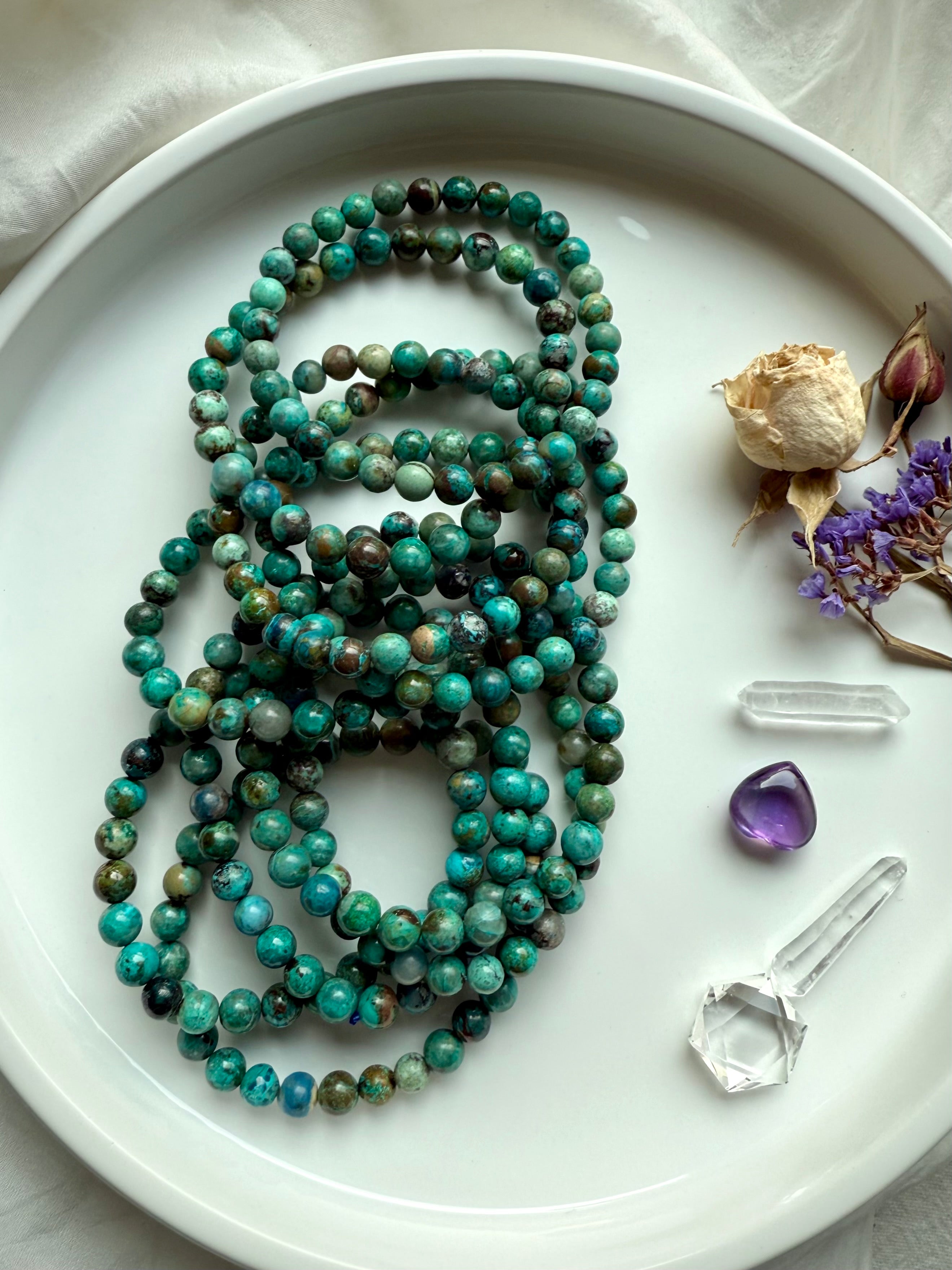  Natural Chrysocolla Shattuckite gemstone bracelets in a pile with vibrant blue-green tones, shown with clear quartz and amethyst crystals