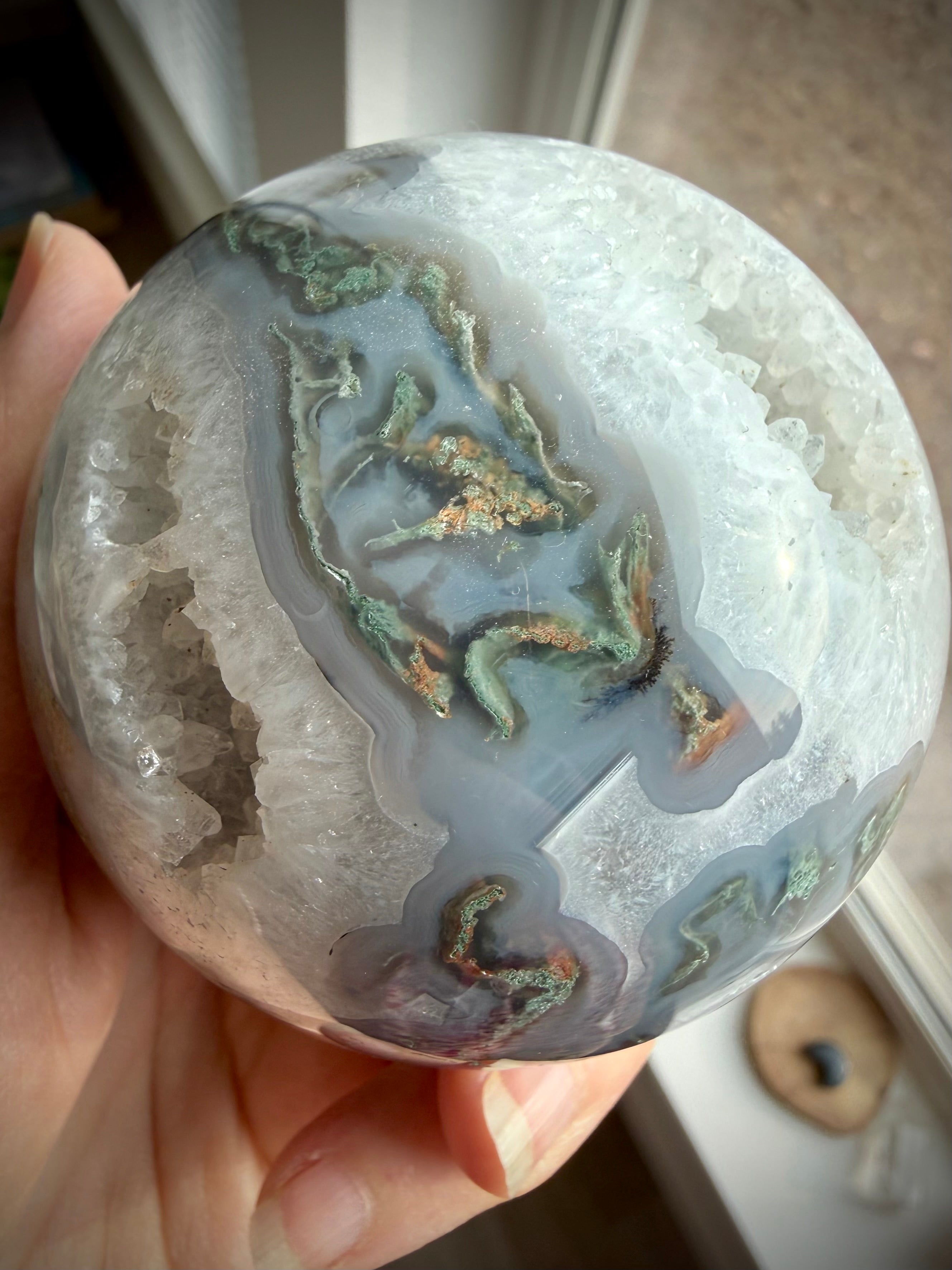 Moss Agate crystal ball with natural Quartz geode, intricate green dendrites and layered blue-gray chalcedony patterns
