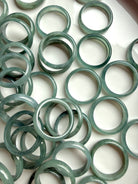 Full tray of rounded Blue Water jadeite band rings, natural jade crystal ring assortment