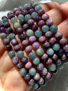 closeup of Ruby Sapphire crystal bead bracelets highlighting natural ruby and sapphire color variation 