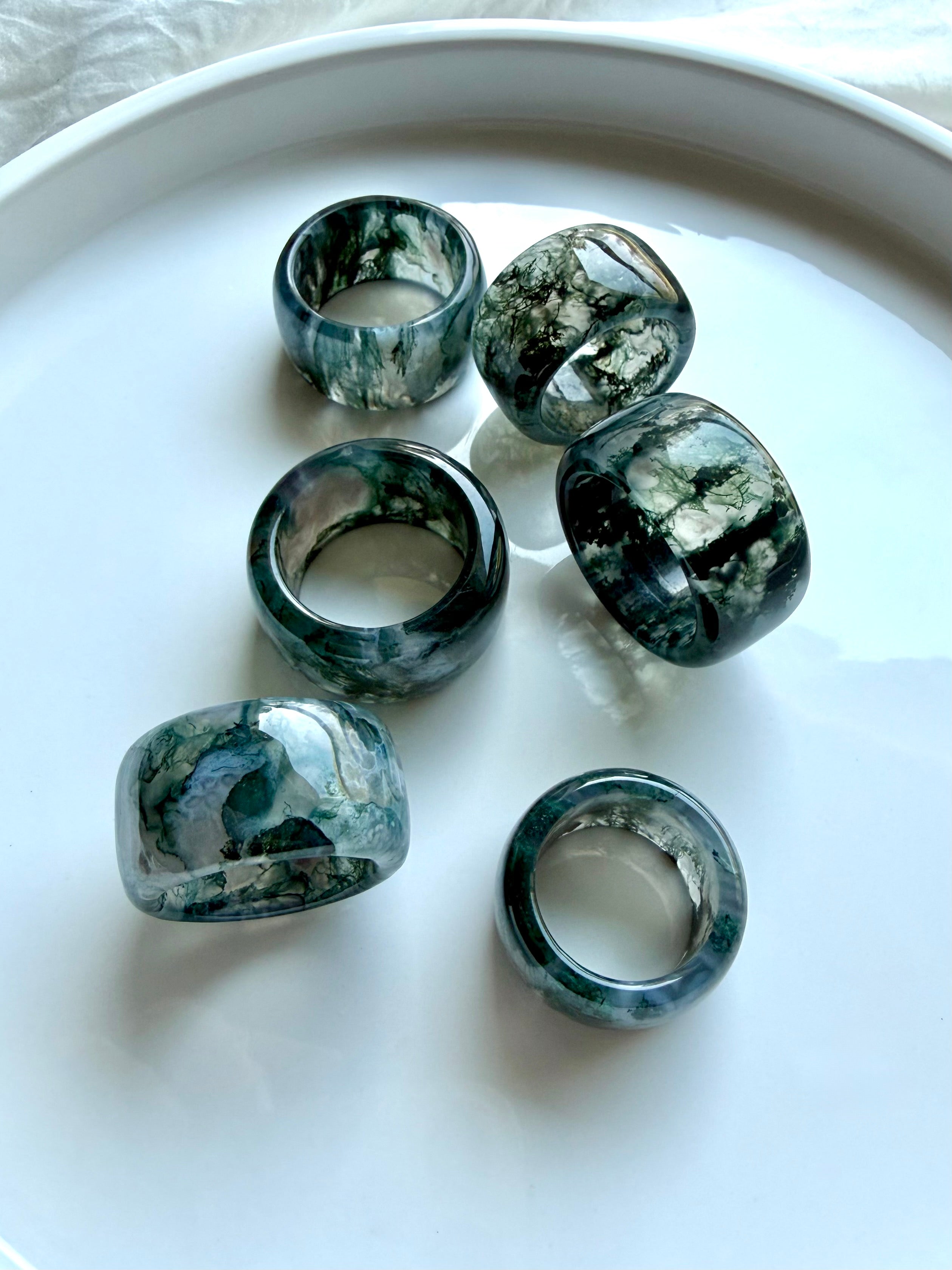 translucent moss agate statement rings with smoky green dendritic patterns and substantial rounded band design