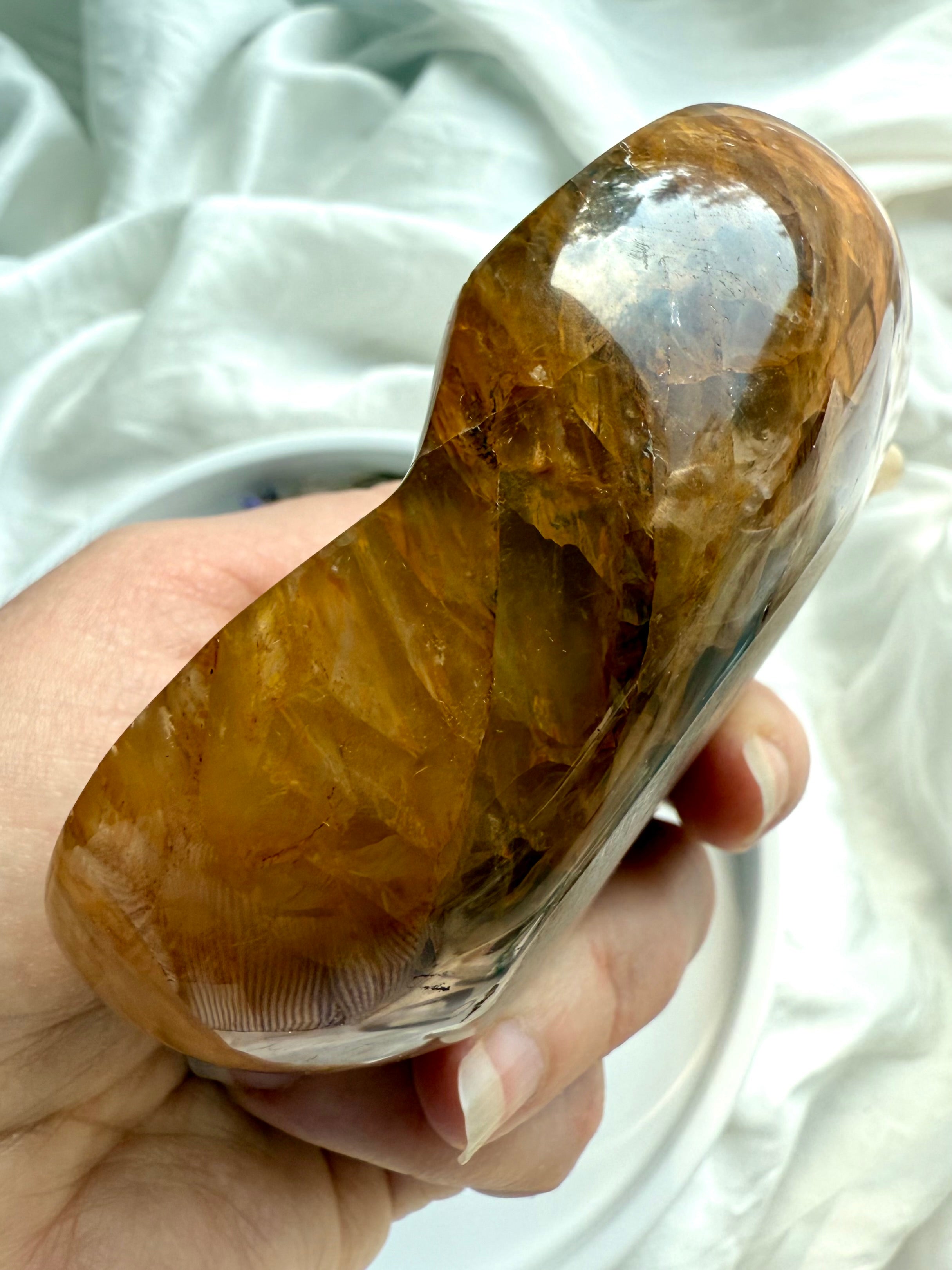 Side angle of oval Golden Healer crystal charging dish showing rim and curved profile