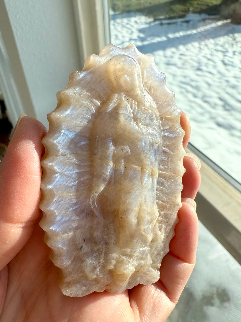 A Crystal Mother Mary Figurine carved from a heavenly piece of Moonstone that shimmers in the light