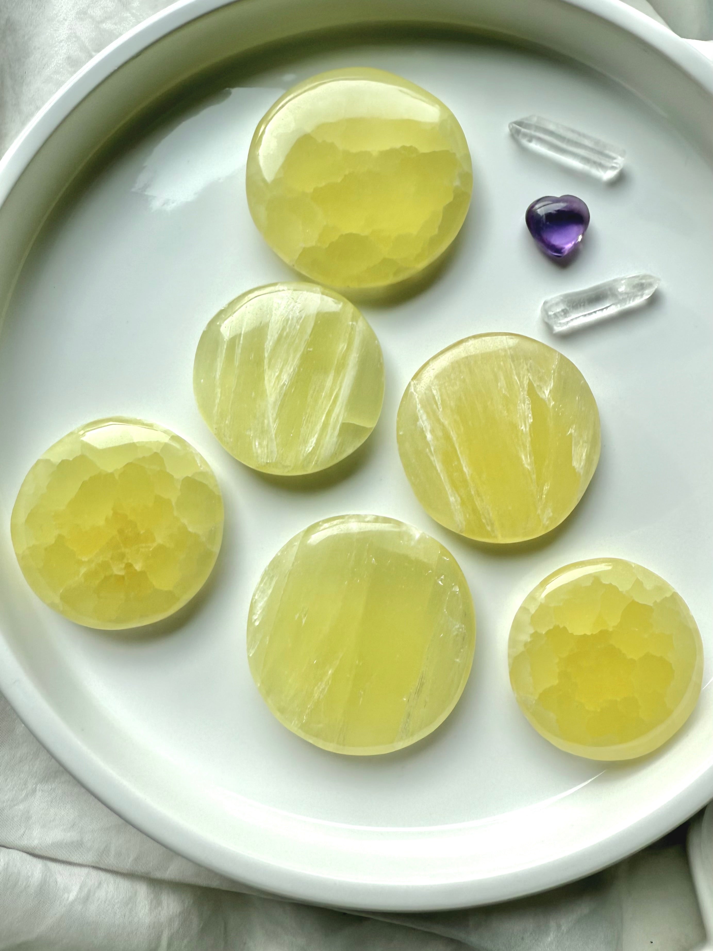Assortment of lemon calcite crystal discs with amethyst and clear quartz accents