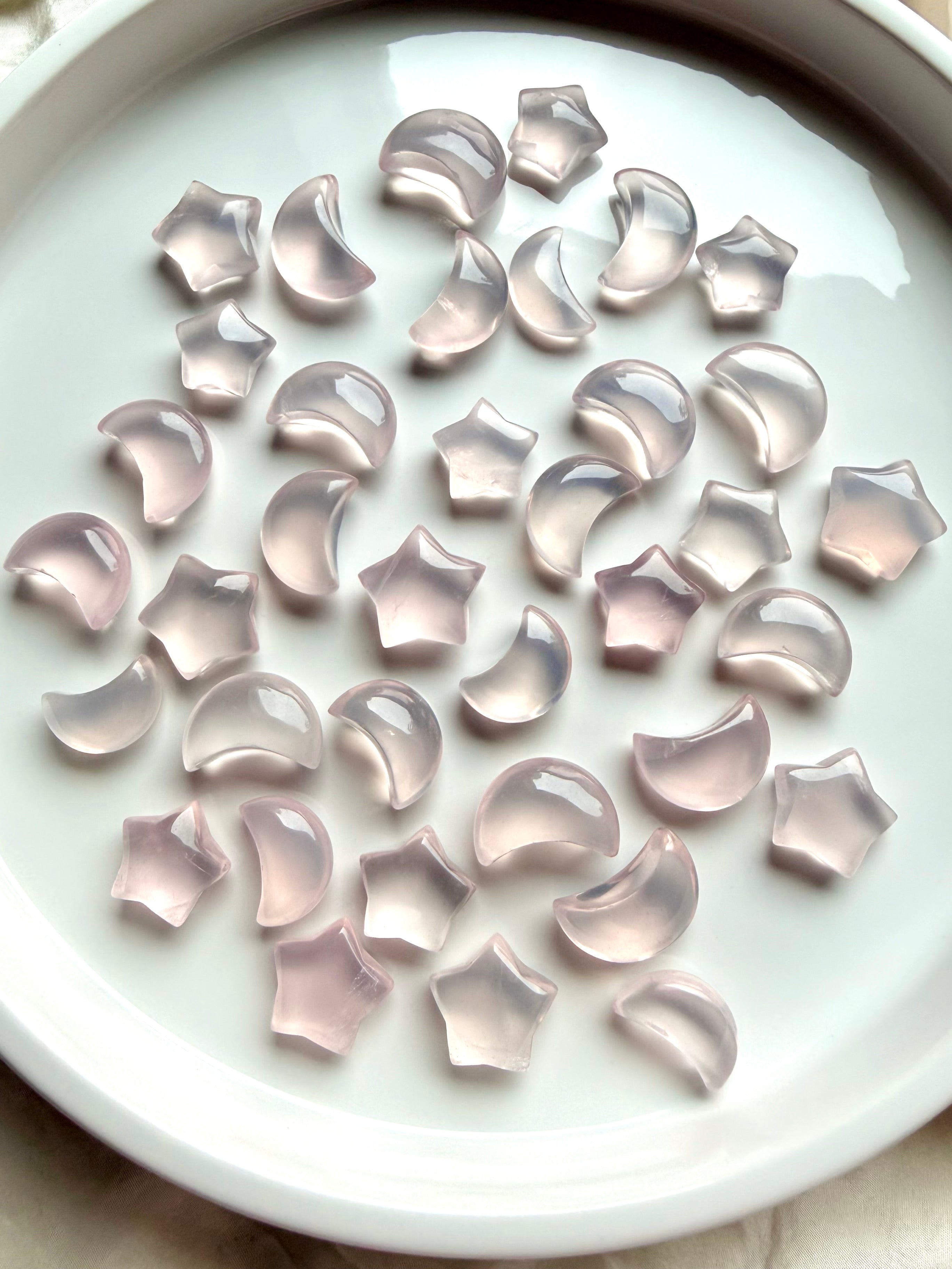 Polished Rose Quartz crescent moons and stars showing natural variation from pale blush to soft lavender pink