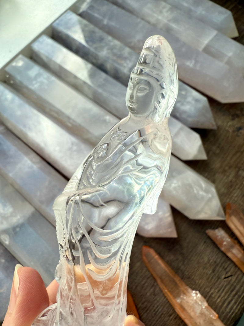 A crystal Quan Yin carving made from Clear Quartz to elevate your sacred space.