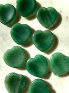 collection of polished green aventurine heart stones displaying natural color variation and organic patterns