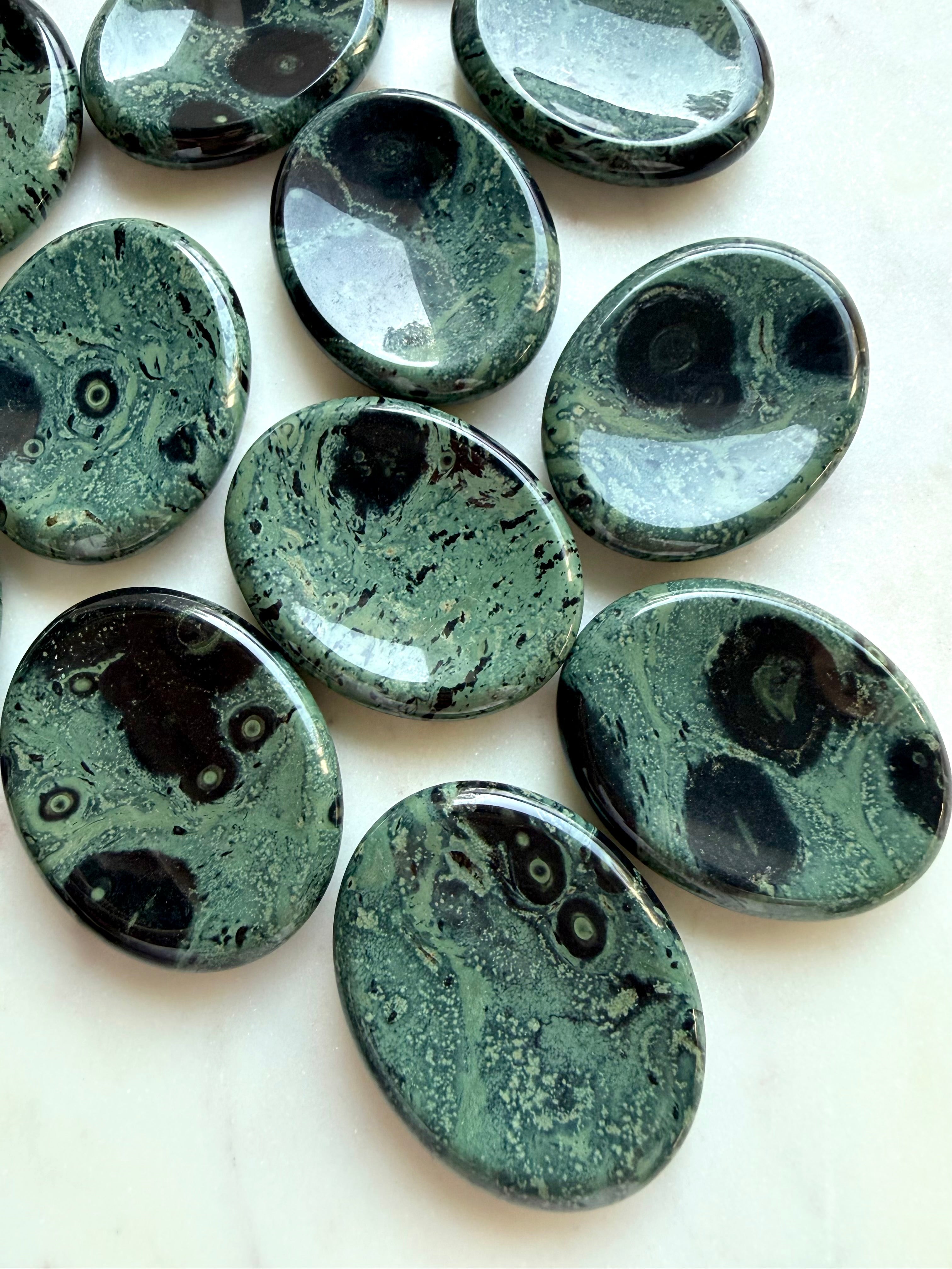 Kambaba Jasper worry stones with deep green, dusky teal, and black orbicular patterns, polished grounding crystals for calm